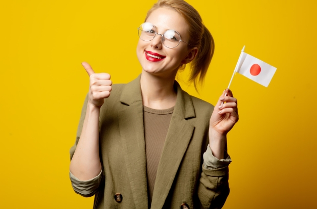 Style blonde woman in jacket with Japanese flag on yellow background